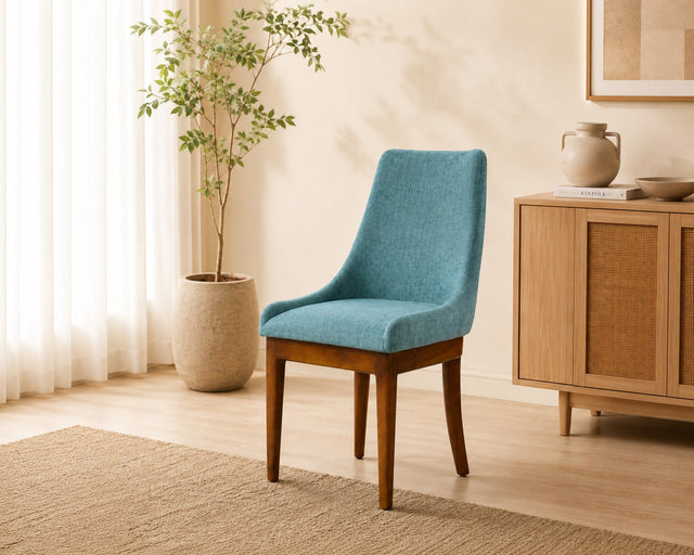 Mira dining chair in teal, shown in a styled room