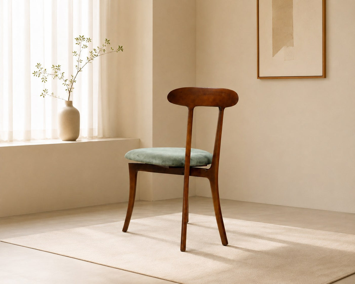 Nora dining chair in sage green, shown in a styled room
