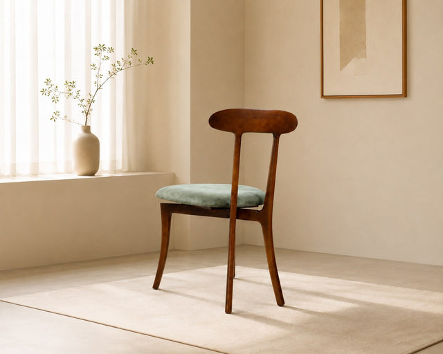 Nora dining chair in sage green, shown in a styled room
